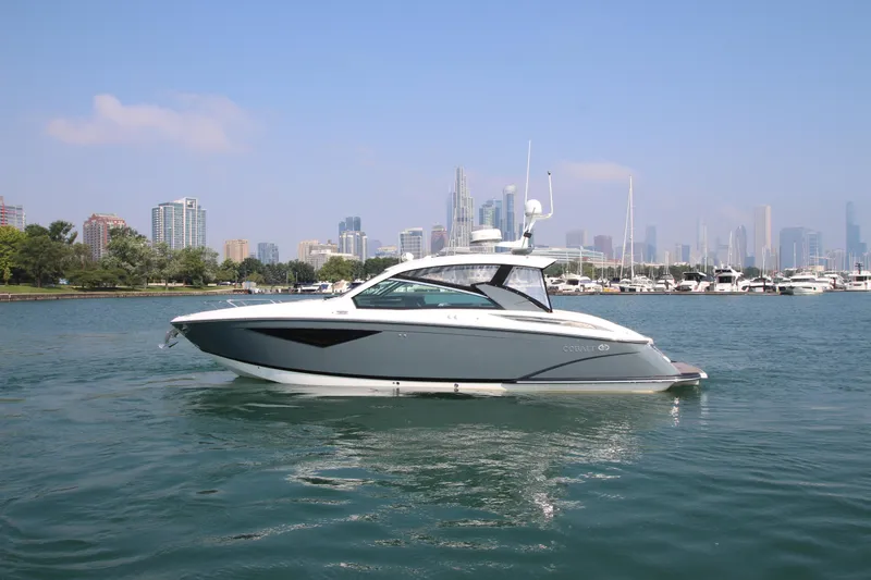  Yacht Photos Pics 2018 Cobalt A36 boat on water with city skyline in background.