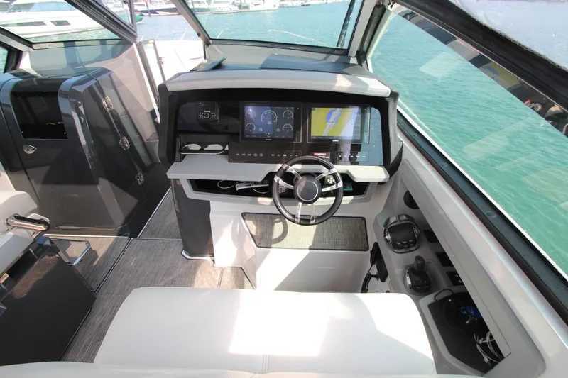  Yacht Photos Pics Interior cockpit of 2018 Cobalt A36 boat with modern navigation system and steering wheel.