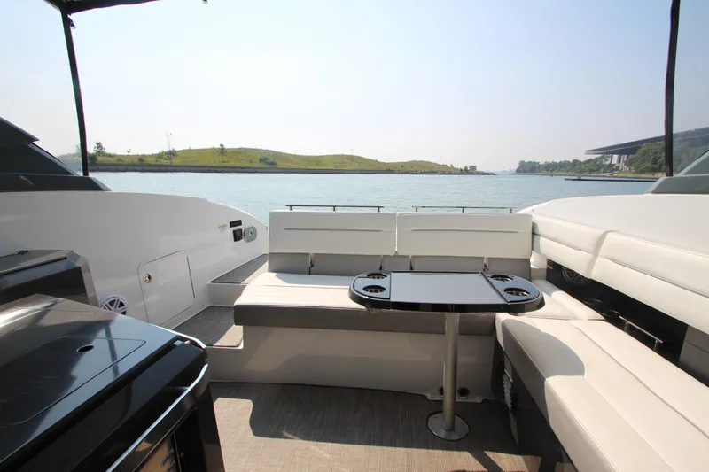  Yacht Photos Pics 2018 Cobalt A36 boat interior with seating and table, overlooking serene water view.