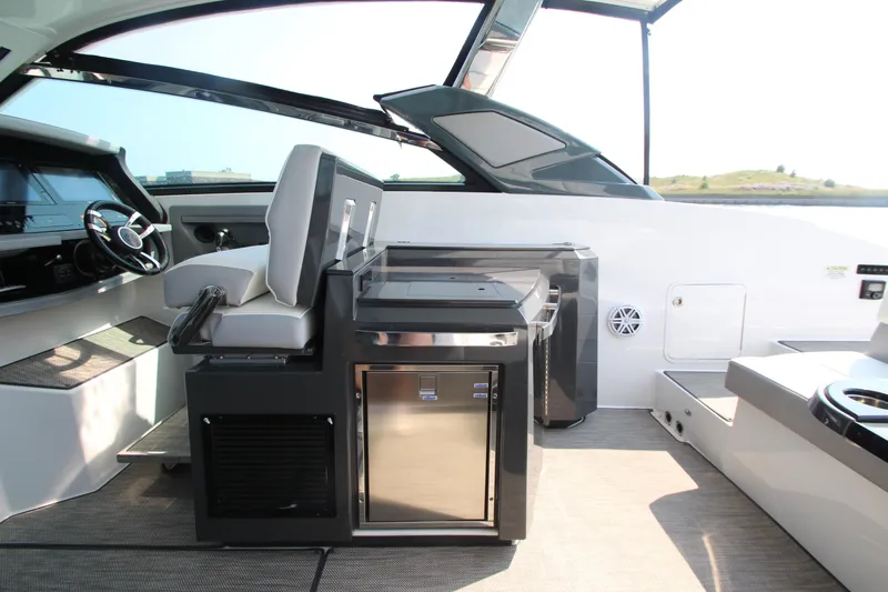  Yacht Photos Pics Interior of 2018 Cobalt A36 boat with helm, seating, and mini fridge.
