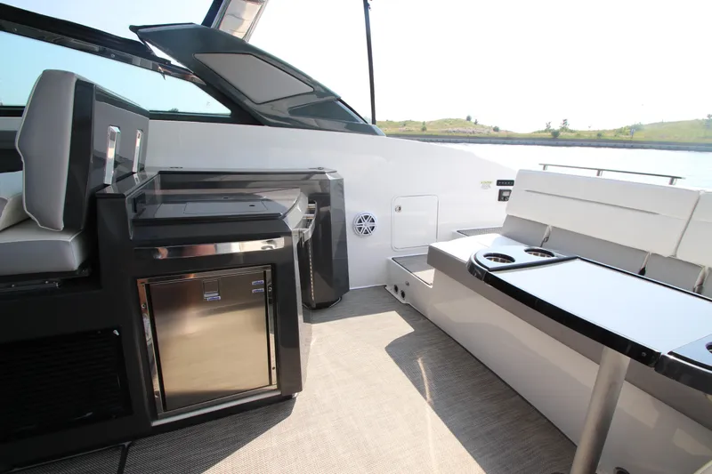  Yacht Photos Pics 2018 Cobalt A36 boat interior with seating and built-in mini fridge.