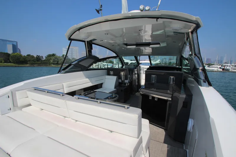  Yacht Photos Pics 2018 Cobalt A36 yacht interior with white seating, sleek design, and marina view.