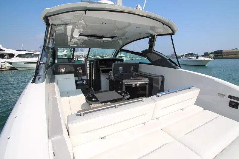  Yacht Photos Pics 2018 Cobalt A36 luxury boat interior with white seating, docked in a marina.