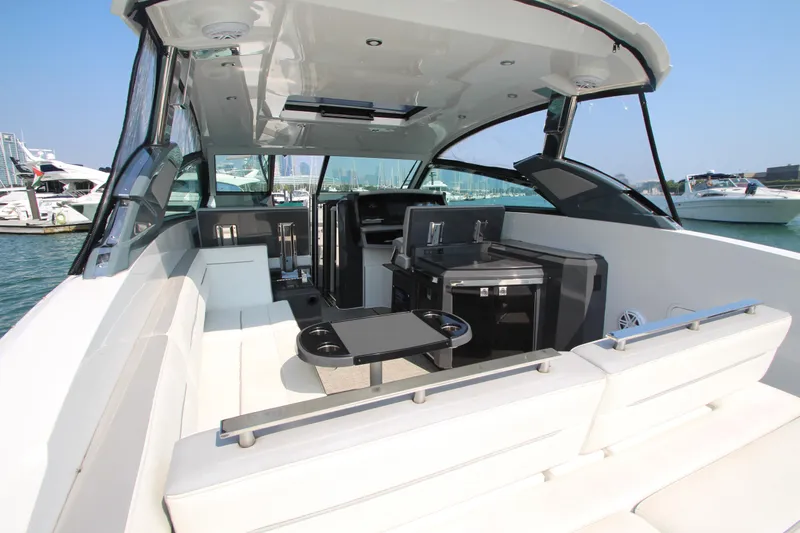  Yacht Photos Pics 2018 Cobalt A36 boat interior with seating and kitchenette, docked in a marina.