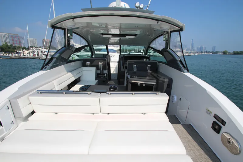  Yacht Photos Pics 2018 Cobalt A36 boat interior with spacious seating, docked in a marina under clear blue skies.