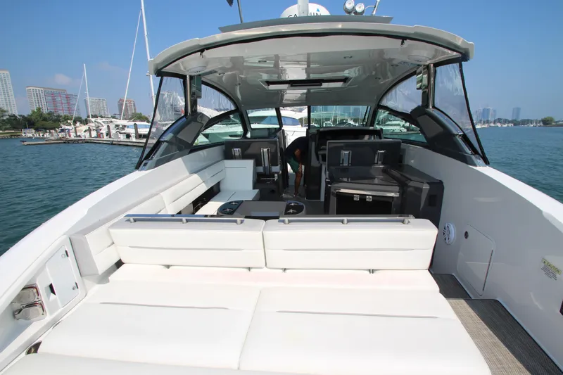  Yacht Photos Pics 2018 Cobalt A36 yacht interior with white seating, docked in a marina.