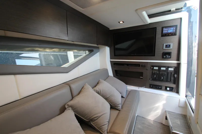  Yacht Photos Pics Luxurious interior of 2018 Cobalt A36 boat with sofa, TV, and control panel.