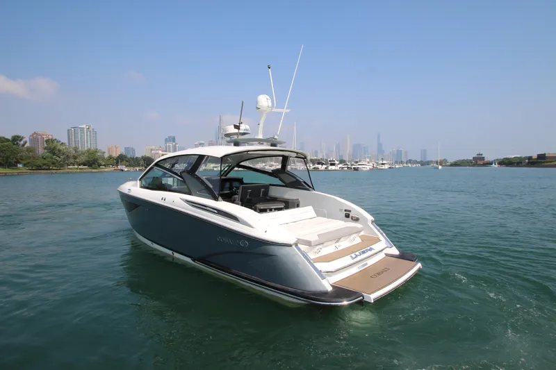  Yacht Photos Pics 2018 Cobalt A36 boat cruising on a scenic urban waterfront.