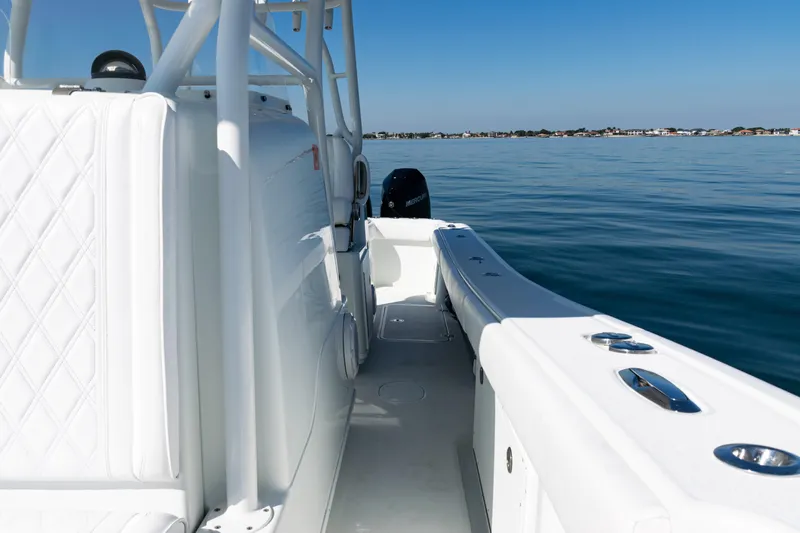  Yacht Photos Pics 2014 Yellowfin 36 Offshore boat on calm water, showcasing sleek design and spacious deck.
