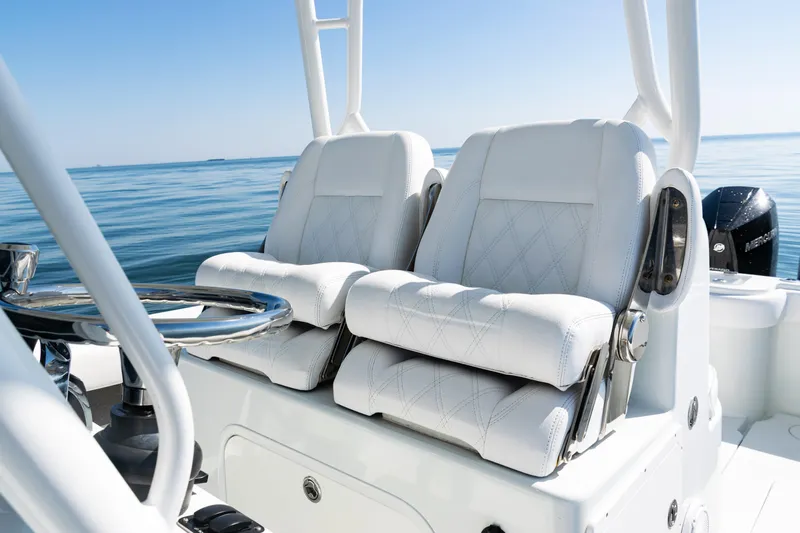  Yacht Photos Pics 2014 Yellowfin 36 Offshore boat with luxurious white seating on calm waters.