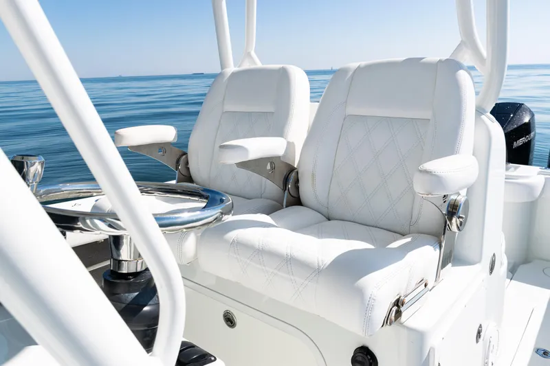 Yacht Photos Pics 2014 Yellowfin 36 Offshore boat with luxurious white seating and steering wheel on calm water.