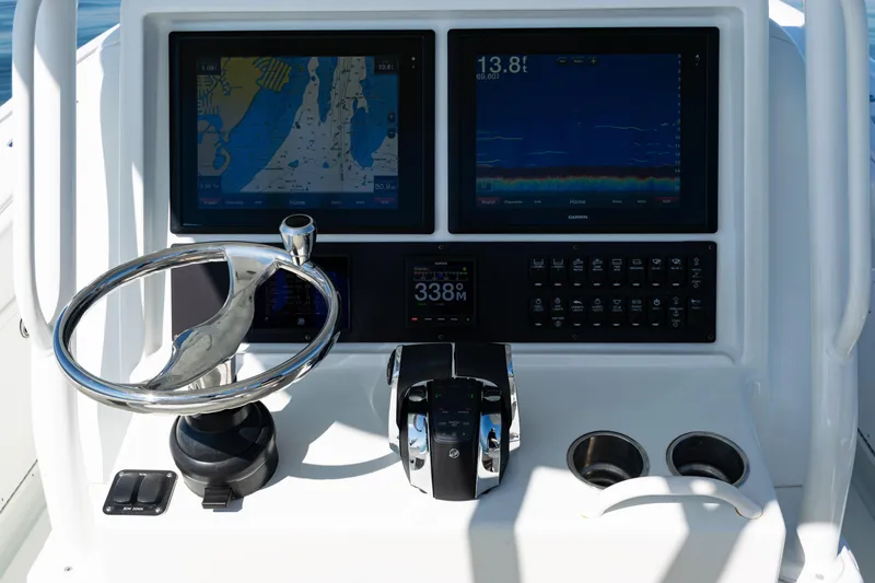 Yacht Photos Pics Control panel of 2014 Yellowfin 36 Offshore boat with navigation screens and steering wheel.