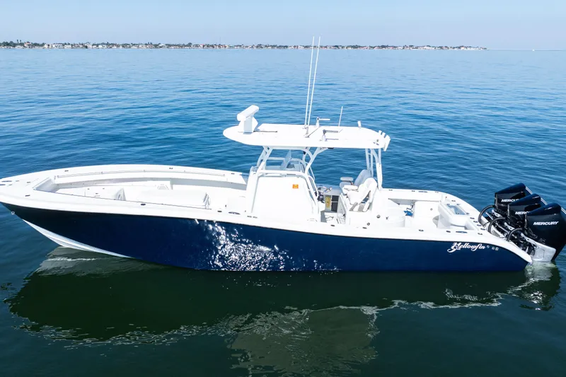  Yacht Photos Pics 2014 Yellowfin 36 Offshore boat on calm blue water, featuring triple Mercury engines.