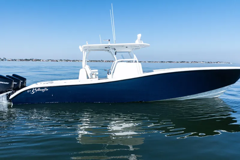  Yacht Photos Pics 2014 Yellowfin 36 Offshore boat on calm water, clear blue sky background.