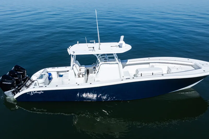  Yacht Photos Pics 2014 Yellowfin 36 Offshore boat on calm blue water, featuring triple Mercury engines.