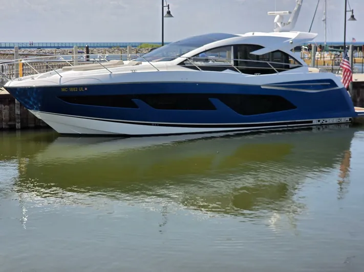  Yacht Photos Pics 2019 Sunseeker Predator 50 yacht docked in a marina, reflecting on calm water.