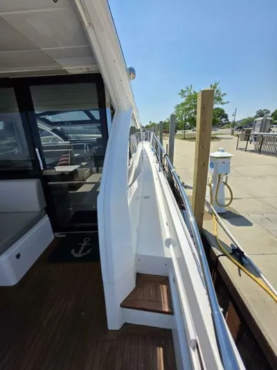  Yacht Photos Pics 2019 Sunseeker Predator 50 yacht docked, showcasing sleek design and spacious deck.