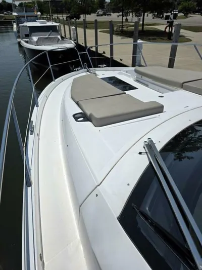  Yacht Photos Pics 2019 Sunseeker Predator 50 yacht docked, featuring sleek design and sunbathing area.