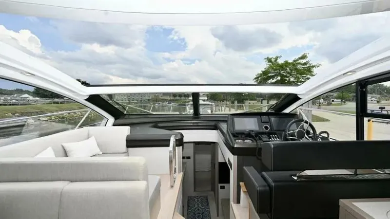  Yacht Photos Pics Interior view of 2019 Sunseeker Predator 50 yacht, featuring modern helm and seating area.