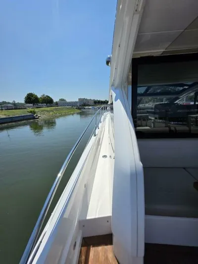  Yacht Photos Pics 2019 Sunseeker Predator 50 yacht cruising along a calm river.