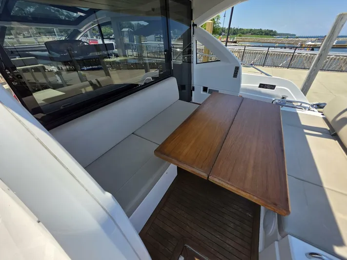 Yacht Photos Pics Luxurious seating area on a 2019 Sunseeker Predator 50 yacht with wooden table.