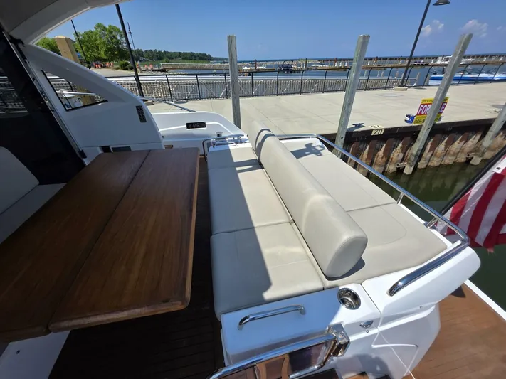  Yacht Photos Pics 2019 Sunseeker Predator 50 yacht with seating area and wooden table at the dock.