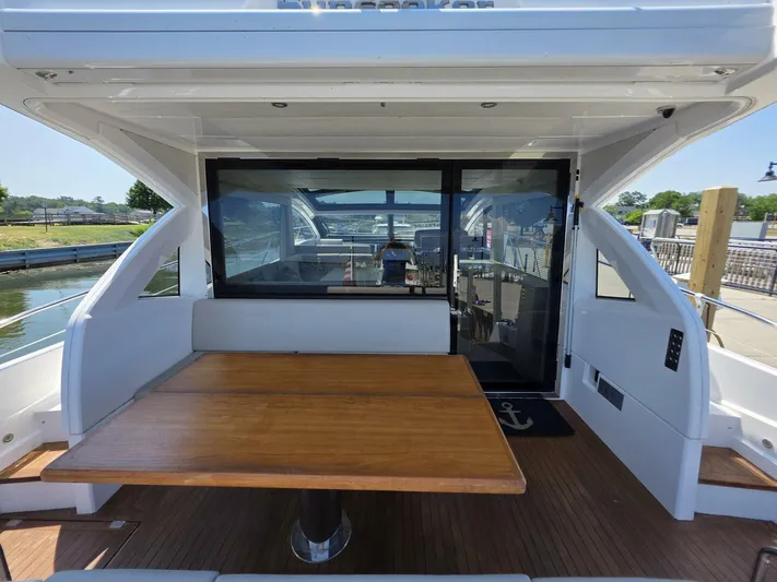  Yacht Photos Pics 2019 Sunseeker Predator 50 yacht interior with wooden table and seating area.