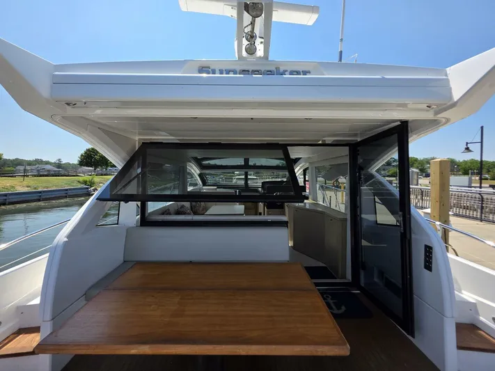  Yacht Photos Pics 2019 Sunseeker Predator 50 yacht with open deck and seating area, docked at marina.