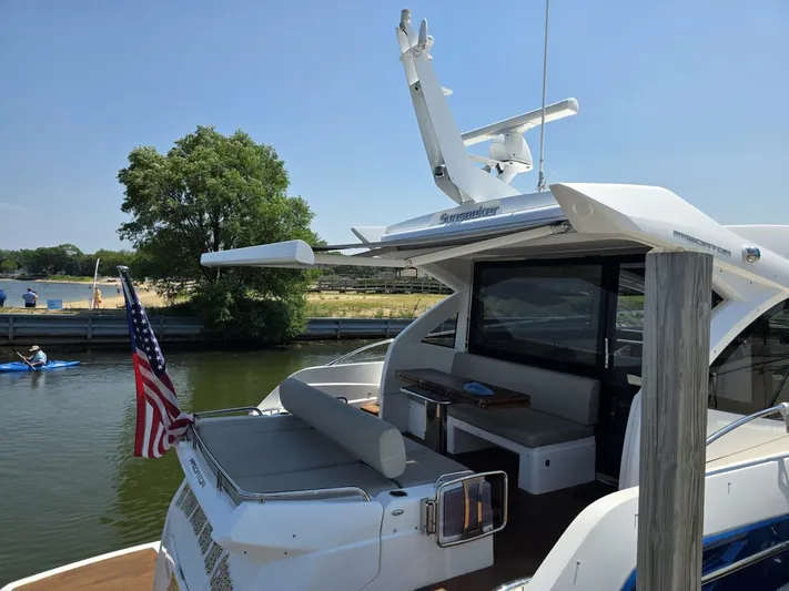  Yacht Photos Pics 2019 Sunseeker Predator 50 yacht docked, featuring sleek design and American flag.