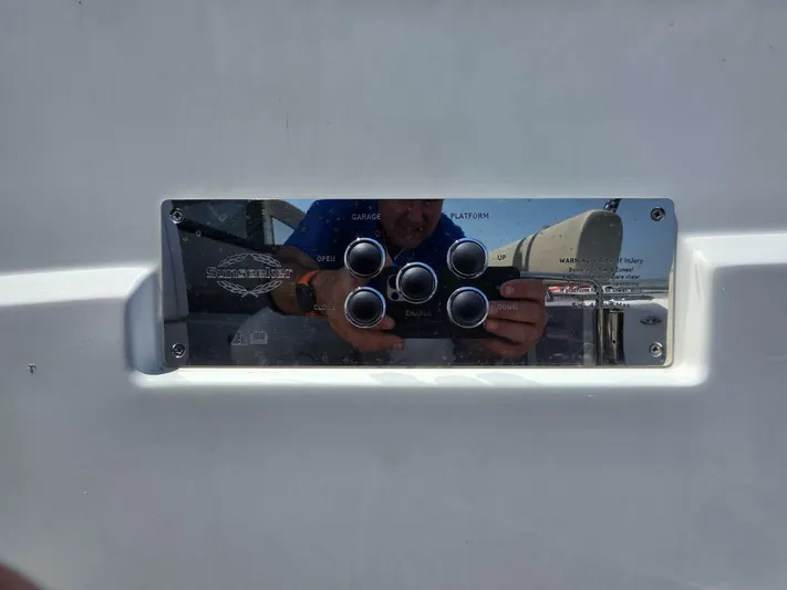  Yacht Photos Pics Control panel on a 2019 Sunseeker Predator 50 yacht, reflecting surroundings.
