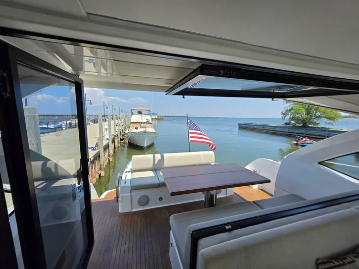  Yacht Photos Pics 2019 Sunseeker Predator 50 yacht docked, featuring a spacious deck with seating and table.