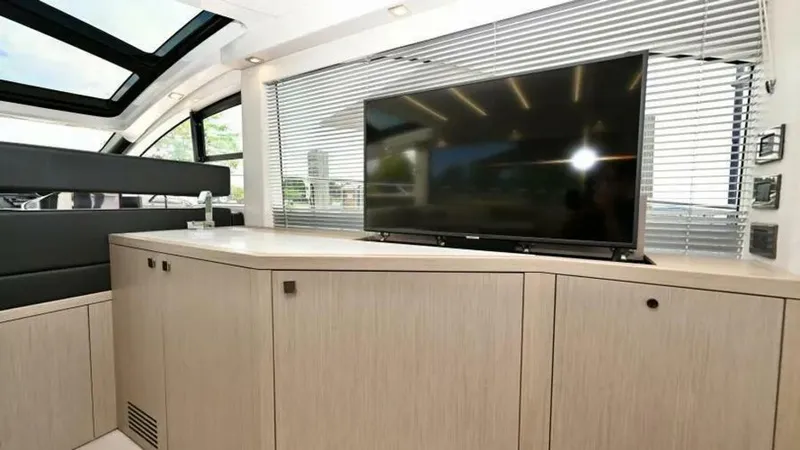  Yacht Photos Pics Interior of 2019 Sunseeker Predator 50 yacht with TV and modern cabinetry.