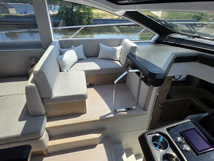  Yacht Photos Pics Luxurious interior of 2019 Sunseeker Predator 50 yacht with modern seating and controls.