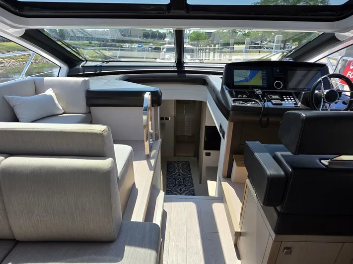  Yacht Photos Pics Luxurious interior of 2019 Sunseeker Predator 50 yacht with modern helm and seating.