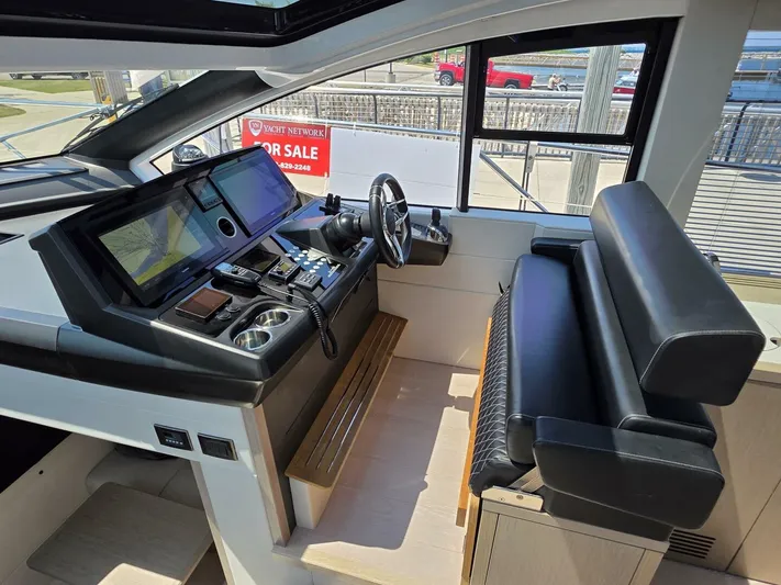  Yacht Photos Pics 2019 Sunseeker Predator 50 yacht helm with modern controls and leather seating.