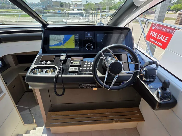  Yacht Photos Pics 2019 Sunseeker Predator 50 helm with navigation controls, steering wheel, and "For Sale" sign.