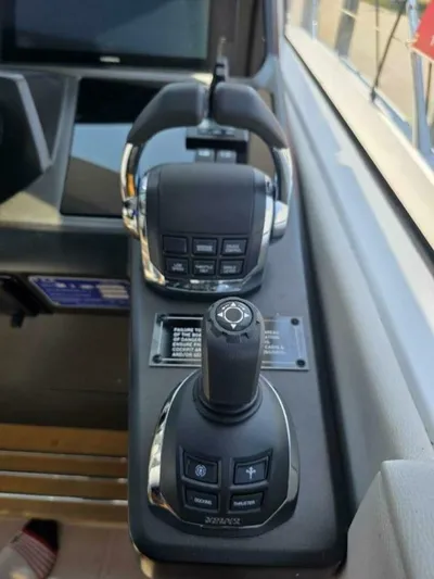  Yacht Photos Pics Control panel of 2019 Sunseeker Predator 50 yacht with joystick and throttle controls.