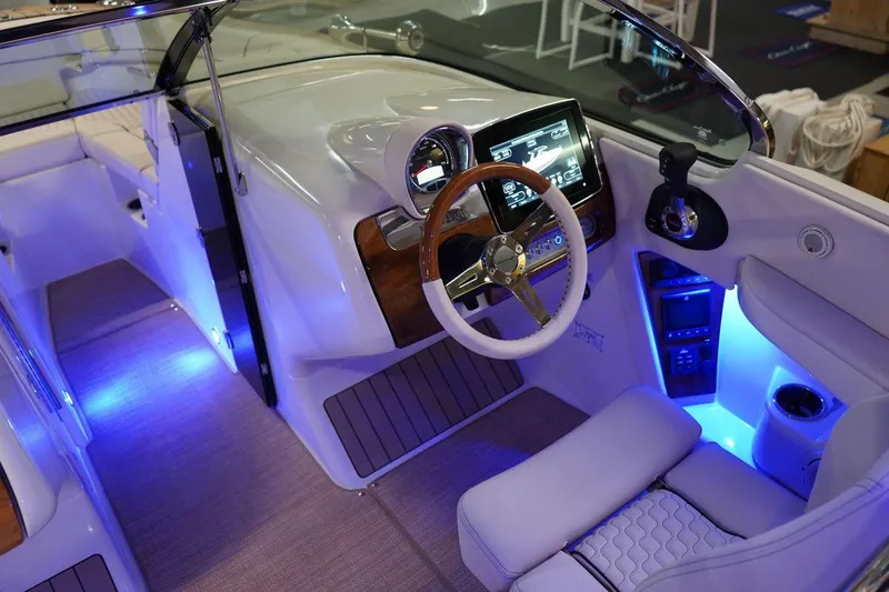  Yacht Photos Pics 2022 Chris-Craft Launch 25 GT boat interior with illuminated dashboard and steering wheel.