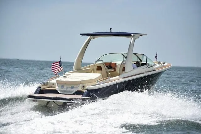  Yacht Photos Pics 2022 Chris-Craft Launch 25 GT cruising on open water with American flag.