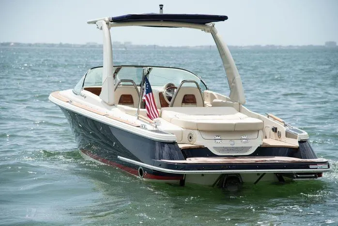  Yacht Photos Pics 2022 Chris-Craft Launch 25 GT boat cruising on open water, rear view.