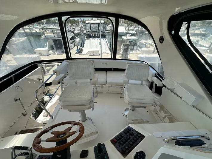 Anna Yacht Photos Pics 2001 Sea Ray 560 Sedan Bridge helm with seating, steering wheel, and control panel.