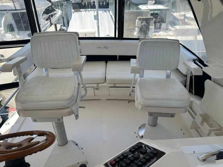 Anna Yacht Photos Pics 2001 Sea Ray 560 Sedan Bridge cockpit with white seating and control panel.