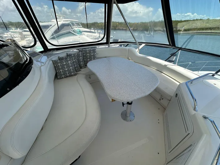 Anna Yacht Photos Pics Luxurious 2001 Sea Ray 560 Sedan Bridge yacht interior with curved seating and table.