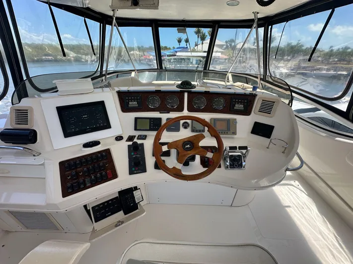 Anna Yacht Photos Pics Helm of 2001 Sea Ray 560 Sedan Bridge yacht with wooden steering wheel and navigation instruments.