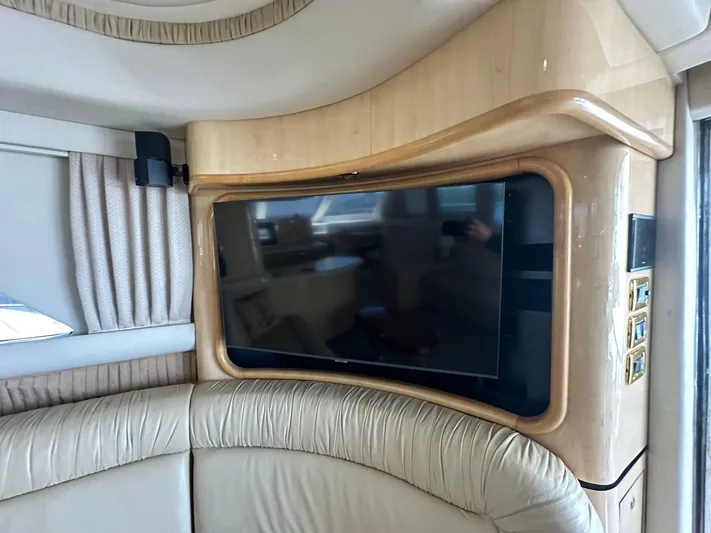Anna Yacht Photos Pics Luxurious interior of 2001 Sea Ray 560 Sedan Bridge with mounted TV and leather seating.
