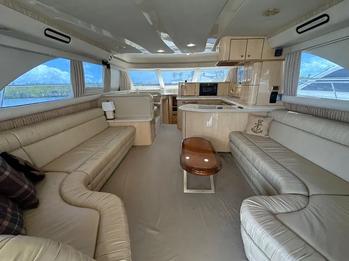Anna Yacht Photos Pics Luxurious interior of 2001 Sea Ray 560 Sedan Bridge yacht with spacious seating and modern kitchen.