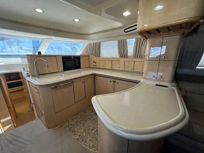 Anna Yacht Photos Pics Luxurious kitchen interior of 2001 Sea Ray 560 Sedan Bridge yacht with modern amenities.