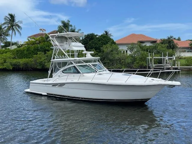  Yacht Photos Pics 2003 Tiara Yachts 3800 Open cruising on a calm waterway with lush greenery.
