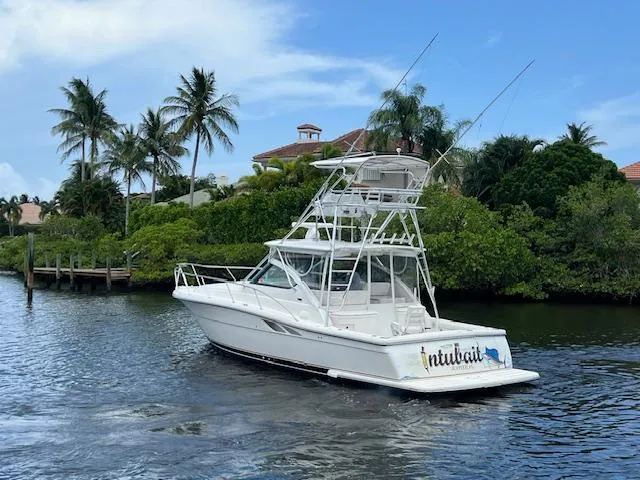  Yacht Photos Pics 2003 Tiara Yachts 3800 Open cruising on a tropical waterway with palm trees.