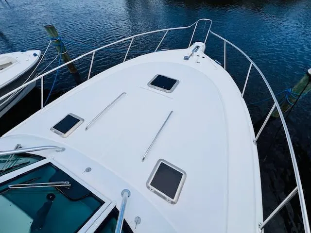  Yacht Photos Pics Tiara Yachts 3800 Open 2003 model, white deck view, docked on calm water.